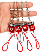 Cargar imagen en el visor de la galería, Llavero de PVC con diseño de bolsa de sangre tipo A, B, O, AB